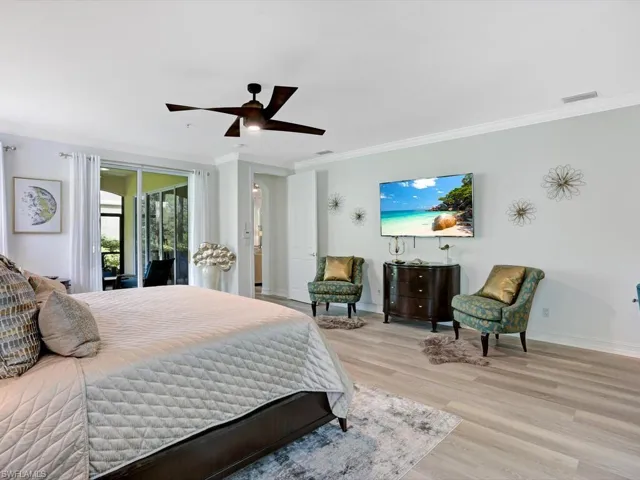 Bedroom featuring crown molding, light wood-style flooring, ceiling fan, and access to exterior