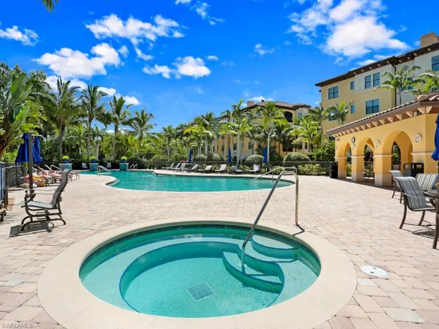 Community pool with a patio area and a community hot tub