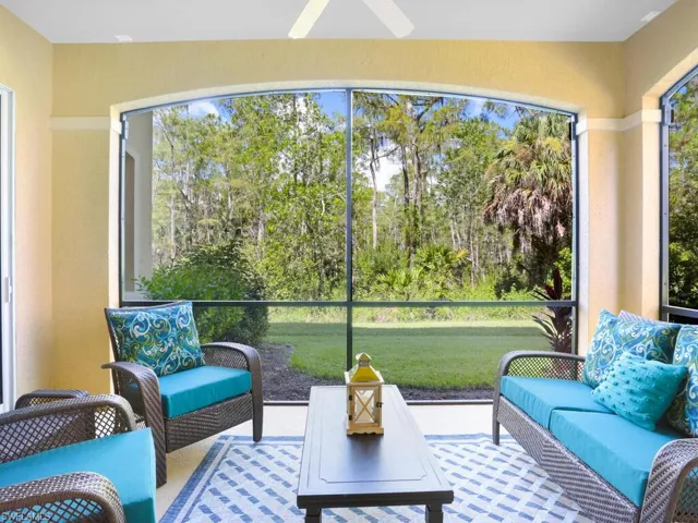 Sunroom / solarium featuring view of scattered trees