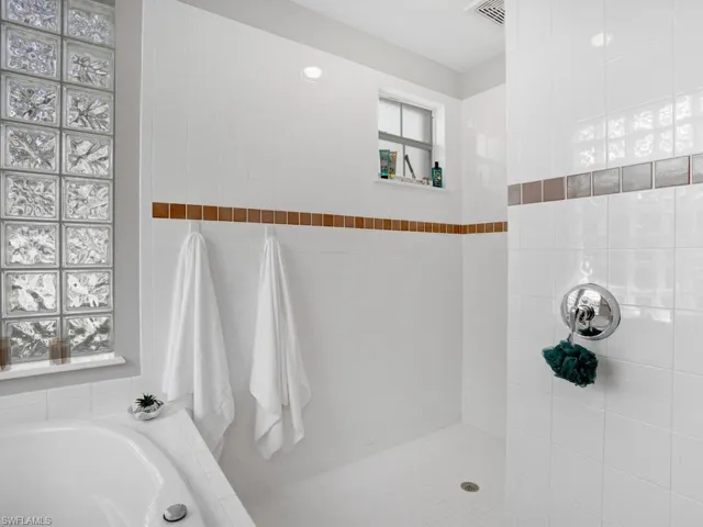 Bathroom with a bath and tiled shower
