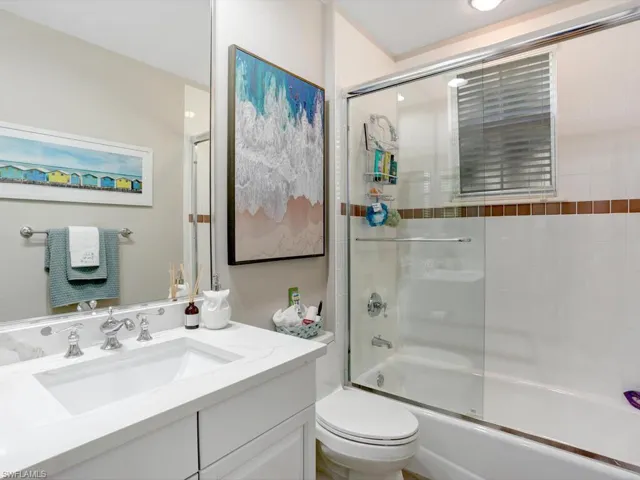 Bathroom with vanity and shower / bath combination with glass door