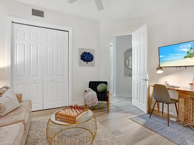 Living area featuring wood finished floors and a desk