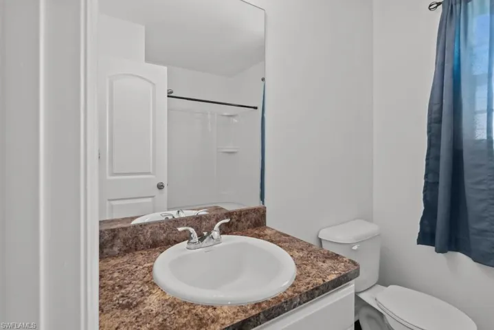 Full bathroom featuring vanity and a shower