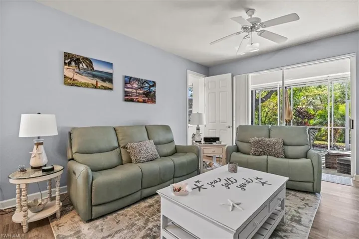 Living area with light wood-type flooring, baseboards, and ceiling fan