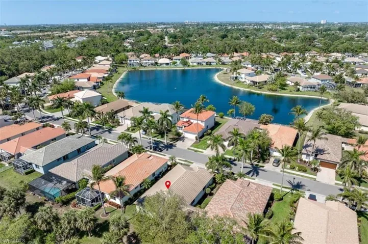 Birds eye view of property with a residential view and a water view