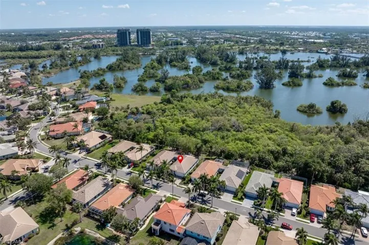 Birds eye view of property featuring a water view and a residential view