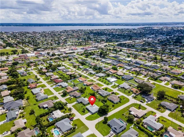 Birds eye view of property with a water view
