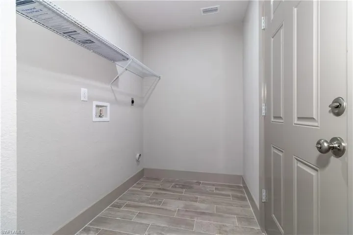 Washroom with hookup for a washing machine and hookup for an electric dryer