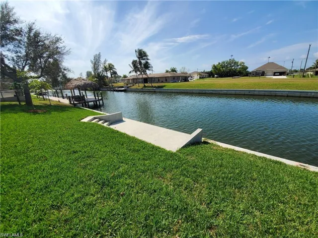 Dock area featuring a water view and a yard