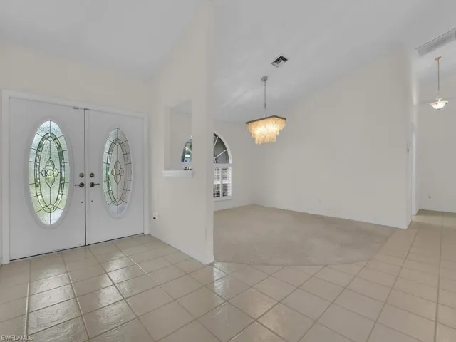 Double entry doors with decorative oval glass inserts