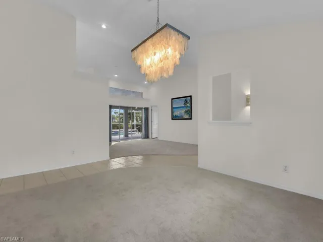 Vaulted ceiling with an elegant chandelier and recessed lighting