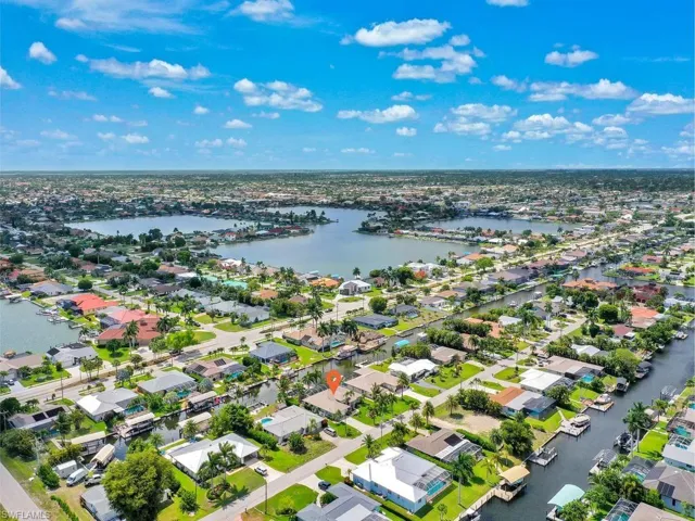 Aerial perspective showcasing a canal-front property with direct water access
