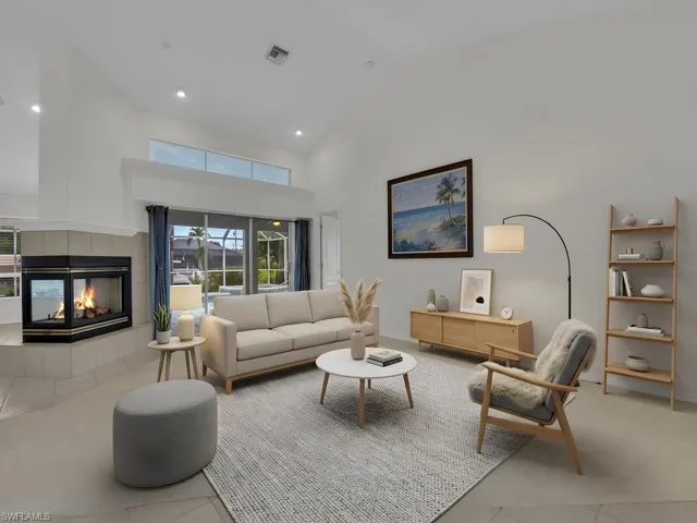 Spacious living area featuring a corner fireplace with a tiled hearth and surround