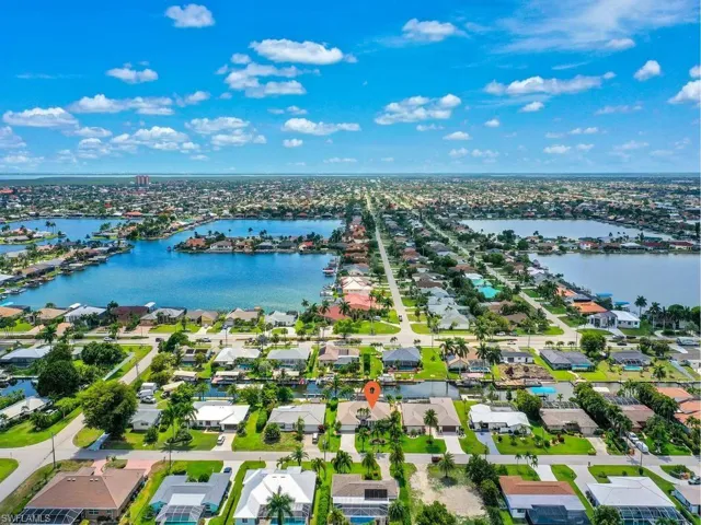 Aerial perspective of a waterfront residential area featuring numerous canals and waterways