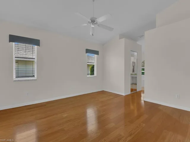 Spacious room with wood-finish flooring and vaulted ceilings