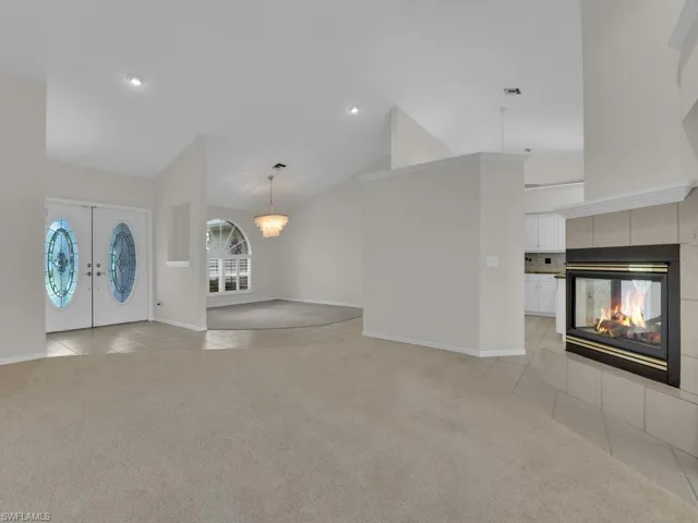Bright interior featuring vaulted ceilings and recessed lighting