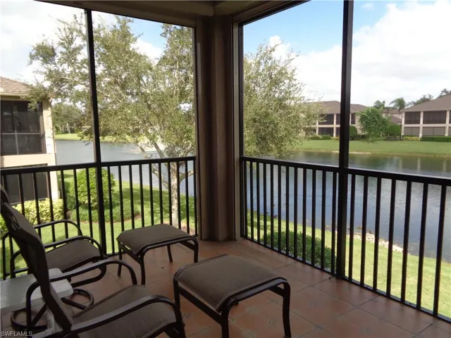 Sunroom featuring a water view