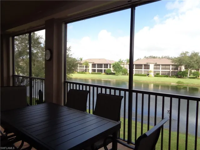 Sunroom featuring a water view