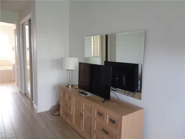 Living area featuring light wood-style floors and baseboards