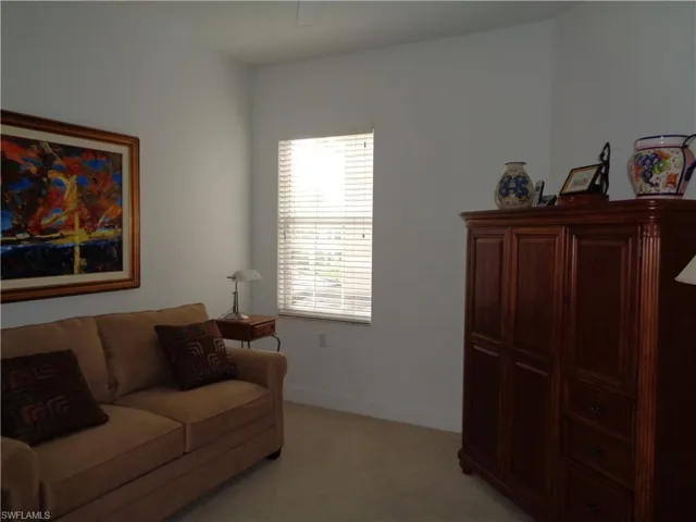 Living room with light carpet and baseboards