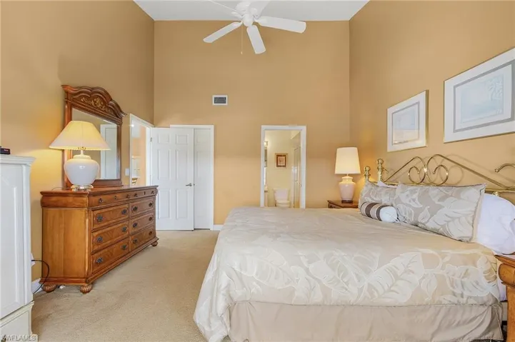 Another view of the Master Bedroom shows the entrance to the ensuite bath and voluminous ceiling height. The walk-in closet is the door on the left.