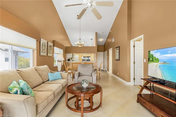 This view is looking in from the lanai into the living area, dining area, and kitchen/foyer areas.