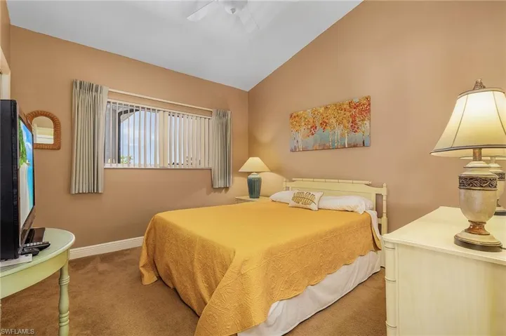 Guest bedroom has vaulted ceilings.