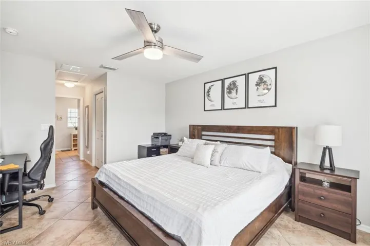 Tiled bedroom featuring a closet and ceiling fan