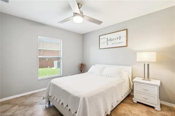 Bedroom featuring ceiling fan and light tile flooring