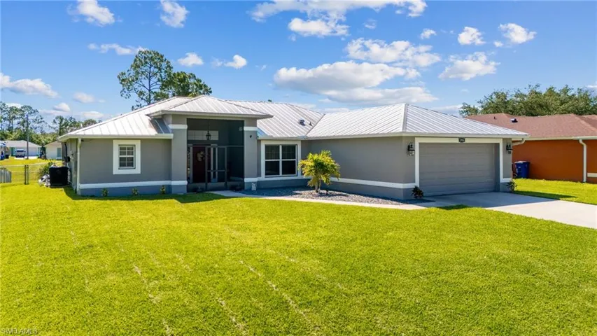 Ranch-style house with a garage and a front yard
