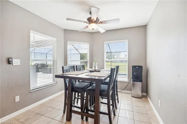 Tiled dining room with ceiling fan