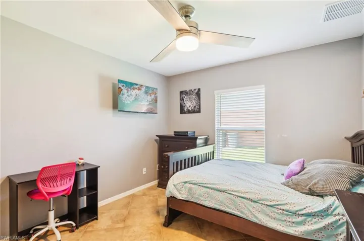 Bedroom featuring tile flooring and ceiling fan