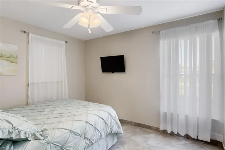 Bedroom featuring a ceiling fan and baseboards