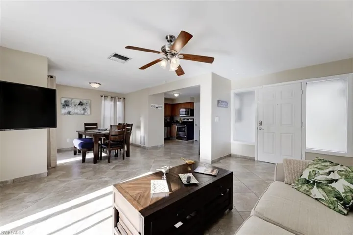 Living room featuring ceiling fan and light tile patterned flooring