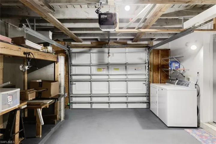 Garage with washing machine and dryer and a garage door opener