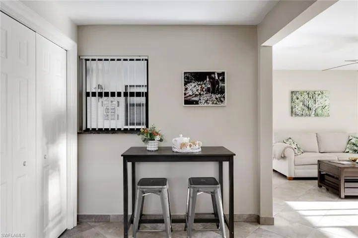 Dining area featuring light tile patterned flooring and ceiling fan