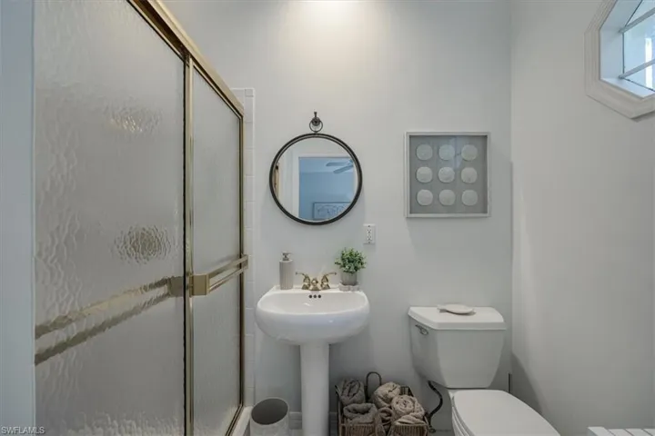 Bathroom featuring a stall shower and toilet