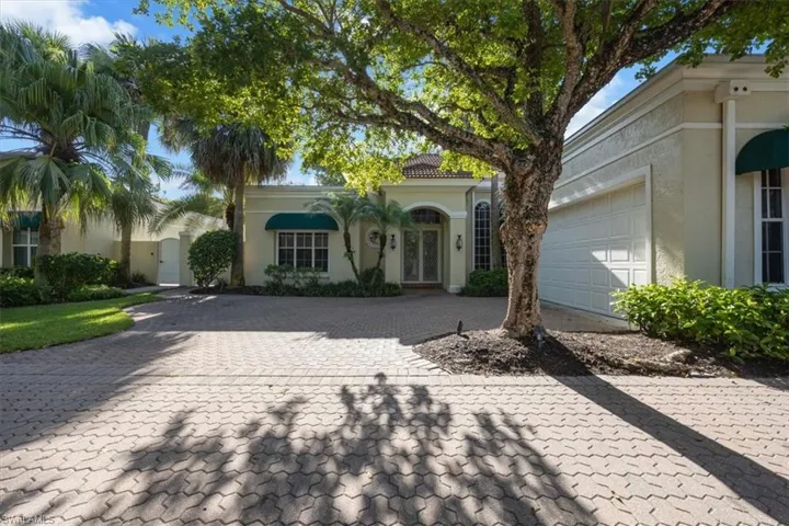 Mediterranean / spanish home featuring decorative driveway, stucco siding, and an attached garage