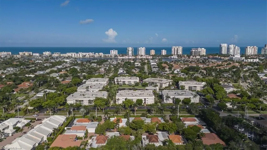 Aerial overview of property's location with nearby urban area and a nearby body of water