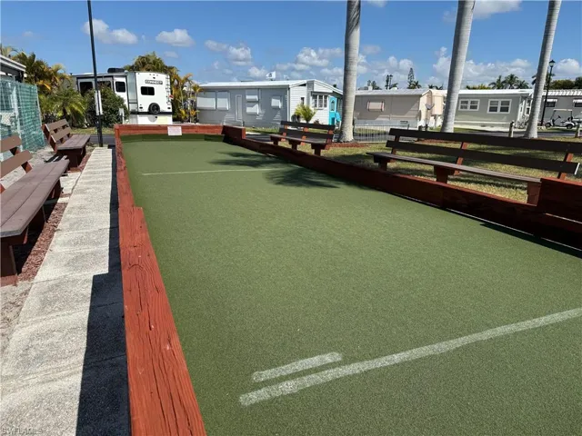 View of property's community with a bocce ball area and a residential view