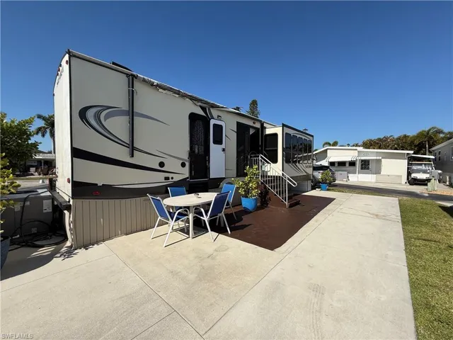 Rear view of property with outdoor dining area