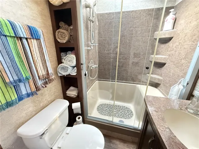 Bathroom with vanity and a shower stall