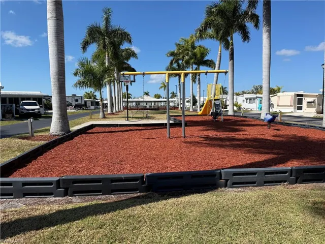 Community play area featuring a yard and a residential view