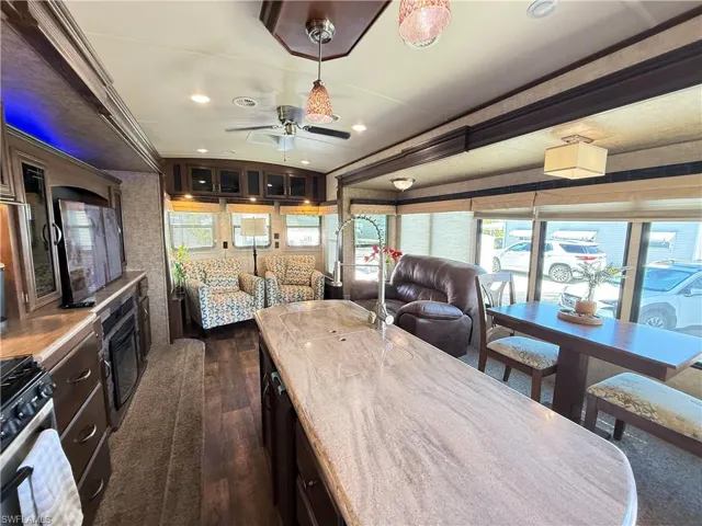 Dining space featuring a barrel ceiling, plenty of natural light, dark wood finished floors, ceiling fan, and recessed lighting
