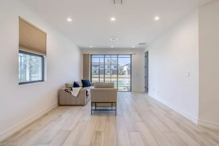 Living room with wood tiled floors and recessed lighting