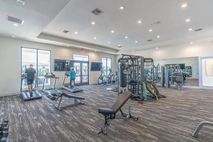 Exercise room featuring french doors and recessed lighting