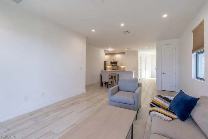 Living area with wood tiled floors and recessed lighting