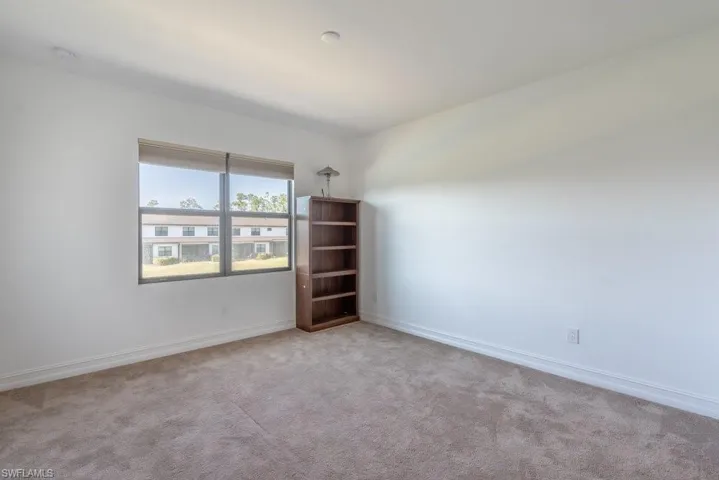 Unfurnished room featuring carpet floors and baseboards