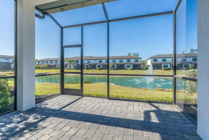 Unfurnished sunroom featuring a water view