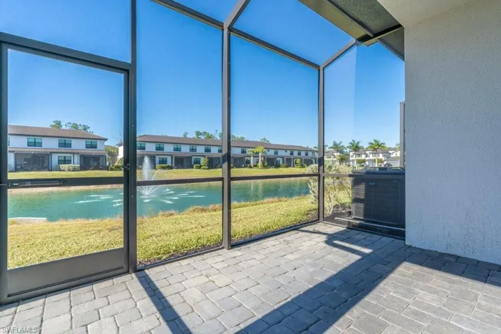 Unfurnished sunroom featuring a water view